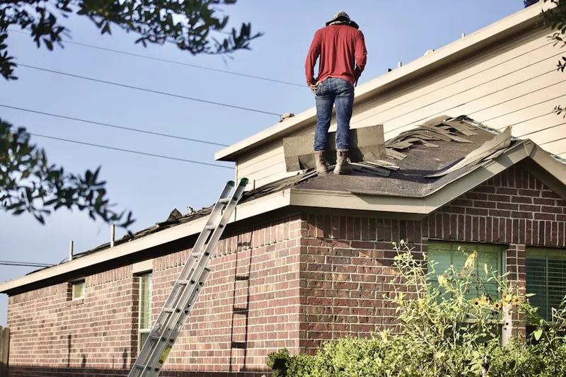 Professional roofer working on a residential roof in Oakhurst Terrace